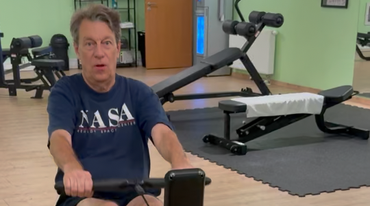 Peter Stevens, Founder of BizBus AG, working out on the hotel's rowing machine while on a business trip in Germany.